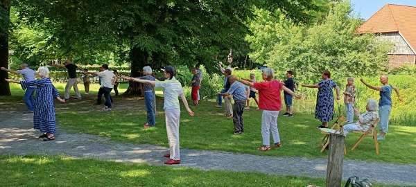 Vereinsmitglieder beim Qi Gong im Garten von Gut Hiddenhausen